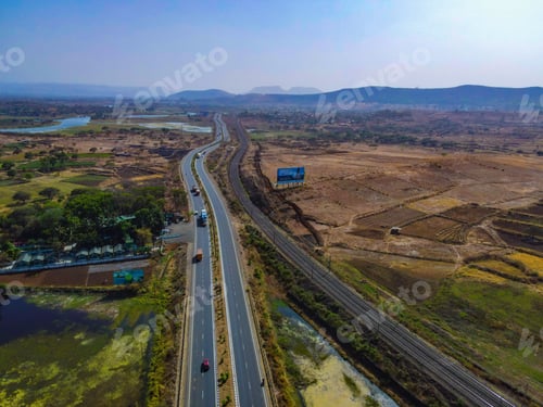 Preview: Aerial shot of a highway stretching through a river and cultivated lands