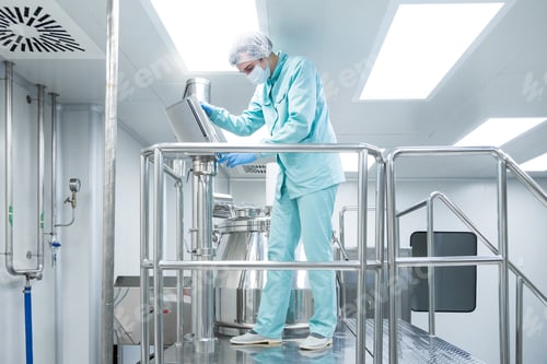 Preview: Pharmaceutical factory man worker in protective clothing operate production line in sterile working