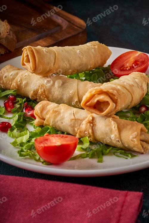 Preview: Fried borek cigarette appetizer plate on a wooden floor