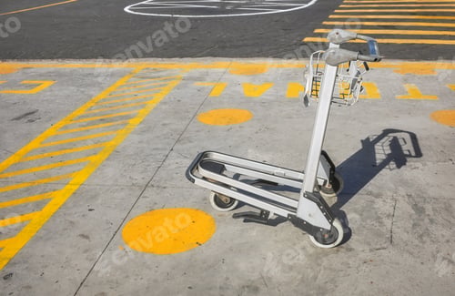 Preview: Luggage cart or airport trolley in an empty parking lot, selective focus.