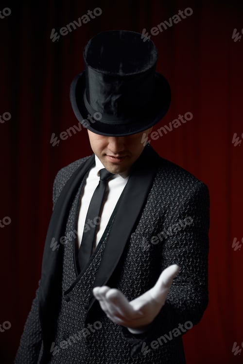 Preview: Magician wearing suit standing with cane on stage decorated red velvet curtain