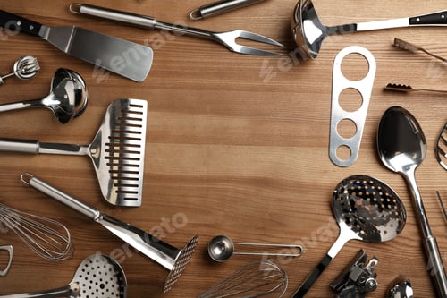 Preview: Flat lay composition with different kitchen utensils on wooden background, space for text