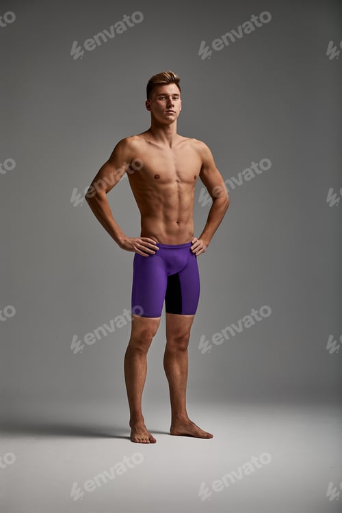 Preview: Young attractive swimmer in excellent physical shape isolated on gray background