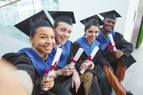 Preview: College graduates taking selfie outdoors