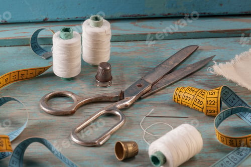Preview: Retro sewing accessories on blue wooden background