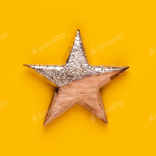 Preview: Christmas star decor on yellow colored background.