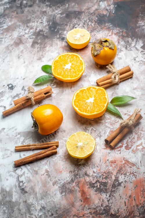 Preview: top view fresh persimmons with orange and cinnamon on light background photo healthy life color