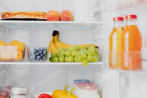 Preview: Open fridge or refrigerator door filled with fresh fruits, vegetables, juice