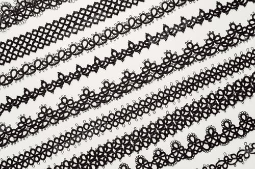 Preview: Top view on tatted accessories. Necklaces and instruments on the table