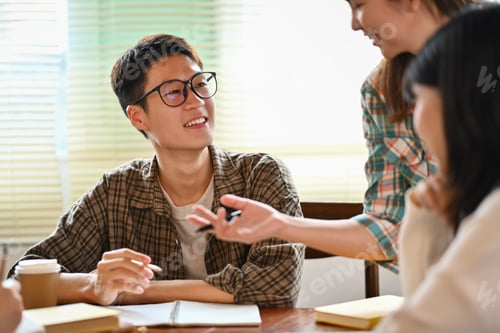 Preview: Young creative team discussing new business opportunity and sharing ideas.