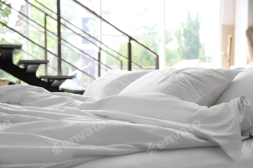 Preview: Soft white pillows on messy bed, closeup