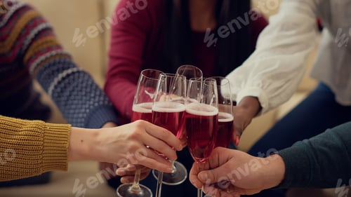 Preview: Group of people clinking glasses of wine to celebrate xmas holiday