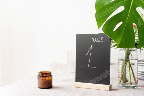 Preview: Mock up table tent with words table 1 on restaurant table with tropical bouquet
