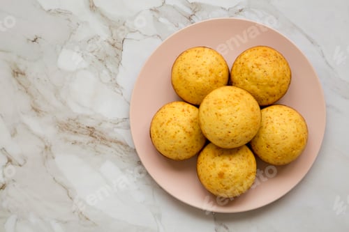 Preview: Homemade Cornbread Muffins on a pink plate, top view. Flat lay, overhead, from above. Copy space.