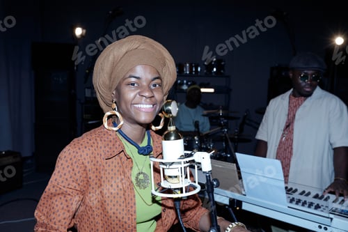 Preview: Smiling Woman Singing into Microphone in Music Studio