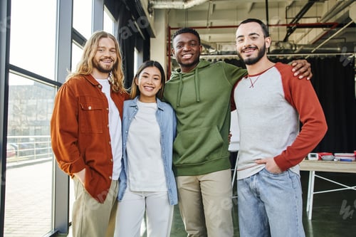 Preview: african american man embracing overjoyed interracial friends in stylish casual clothes looking