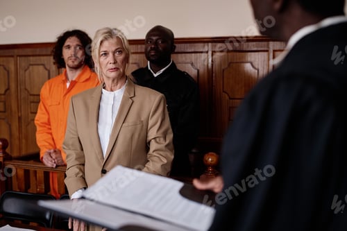 Preview: Focus on mature female attorney listening to impartial judge with open folder