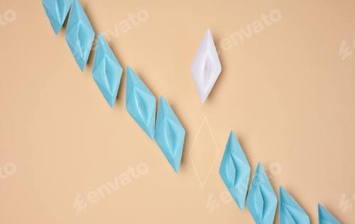 Preview: A line of blue origami paper boats with one white and the outline of the missing one