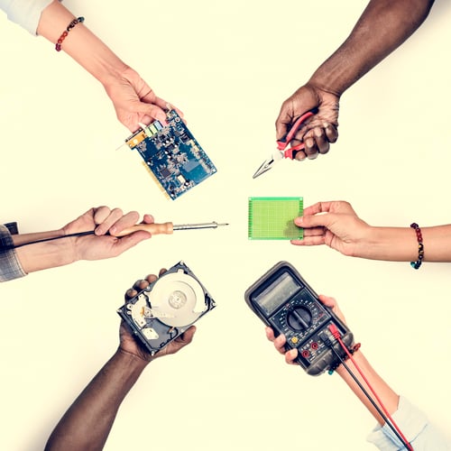 Preview: Group of hands holding computer electronics parts isolated on white