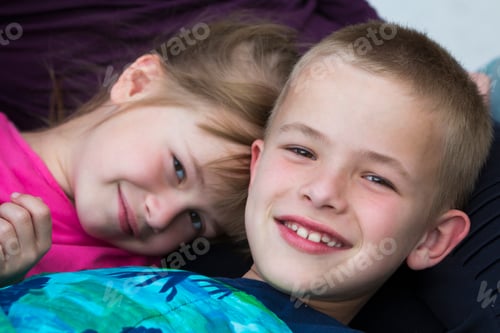 Preview: Close-up portrait of two small cute blond happily smiling children