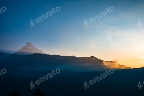 Preview: Sunrise over misty mountain peaks