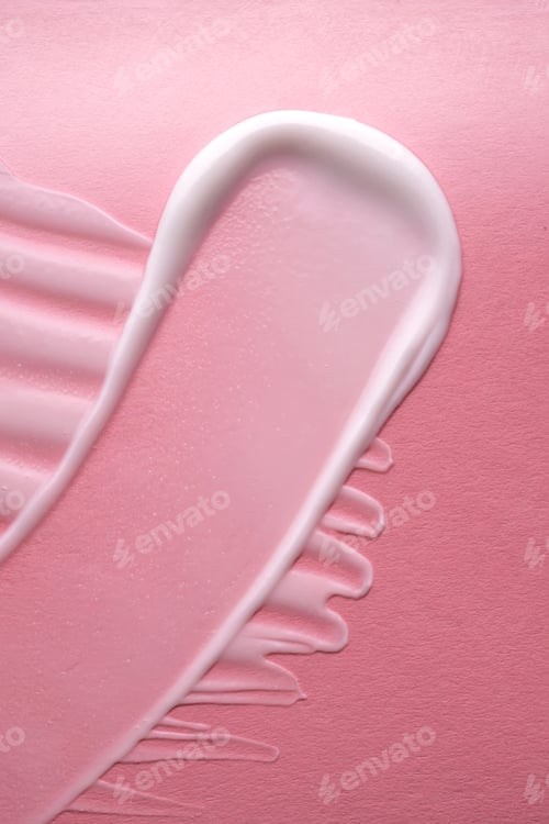 Preview: White cream on a pink background. Texture