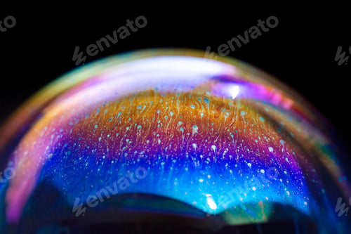 Preview: Multicolored rainbow in a bubble. Abstract texture inside of the soap bubble, macro photography.