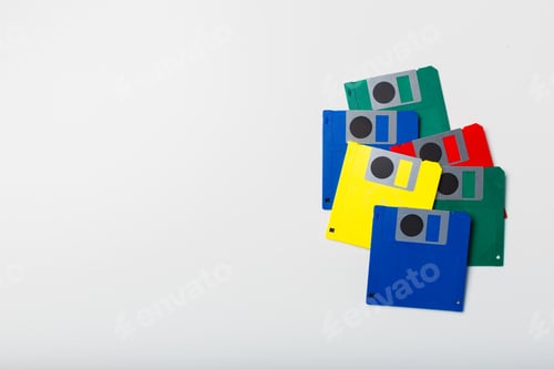 Preview: Colorful floppy disks stacked on a white surface