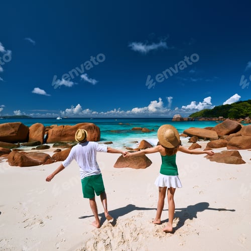 Preview: Couple In Green Having Fun On A Tropical Beach At Seychelles