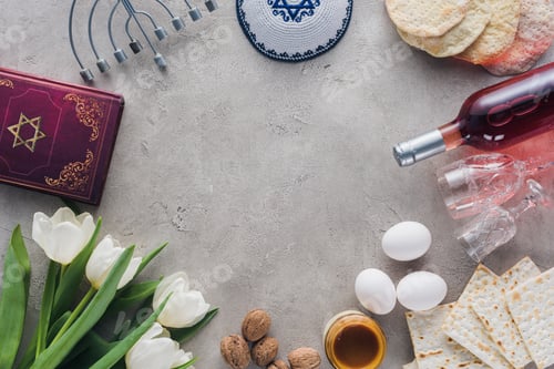 Preview: top view of traditional book with text in hebrew, menorah and kippah on concrete table