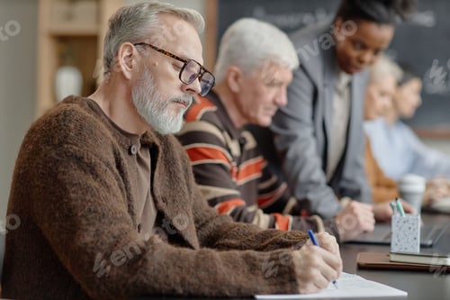 Preview: Middle Aged Caucasian Man Taking Notes during Adult Education Class Indoors