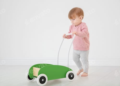 Preview: Cute baby playing with toy walker, indoors