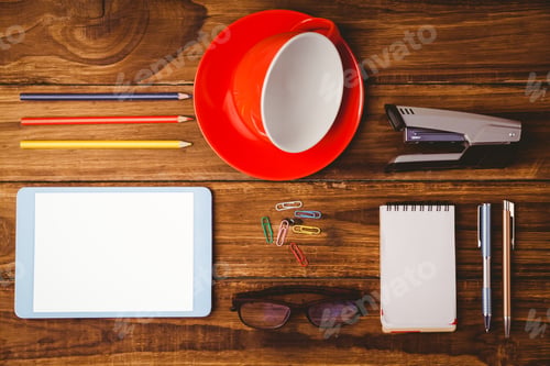 Preview: Tablet next to cup and notepad on wooden table