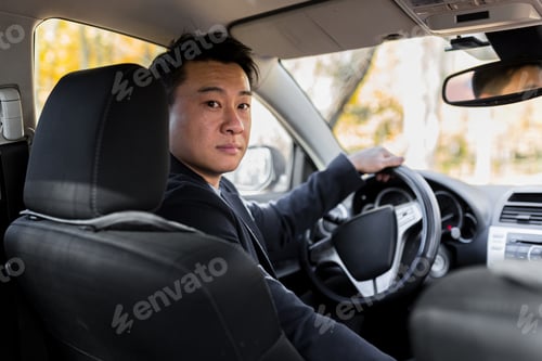 Preview: Successful businessman car salesman Male Asian driver behind the wheel