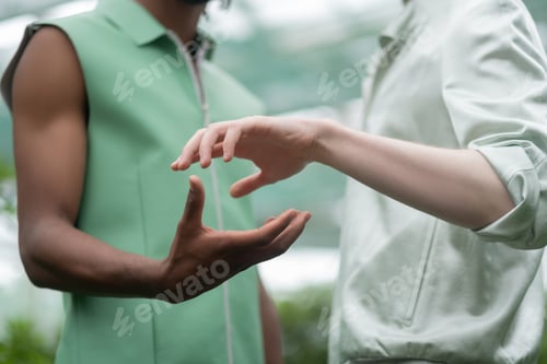 Preview: Models standing and posing while almost touching hands