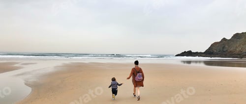 Preview: Mother and child run in the beach
