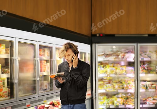 Preview: Man Choosing Frozen Food From A Supermarket Freezer