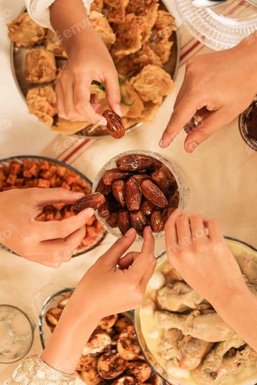 Preview: Hands Take Dates Fruit or Kurma, Concept Buka Bersama, Sharing Food during Ramadan Fasting Month