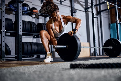 Preview: Strong athletic lady getting ready for the weight-lifting workout