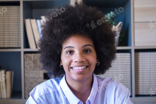 Preview: Close-up portrait of attractive dark skinned young woman with curly Afro hairstyle.