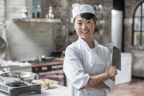 Preview: Portrait of smiling female chef in kitchen