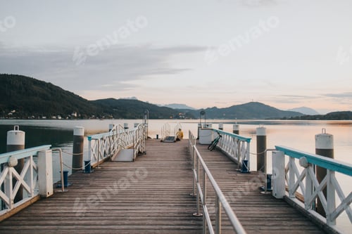 Preview: Wooden dock with a chair beside the water's edge