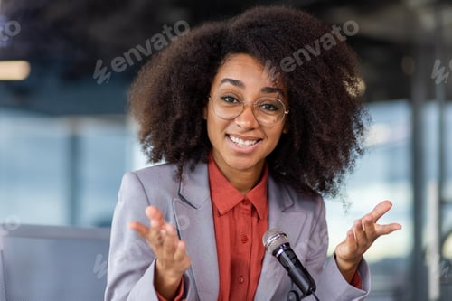 Preview: A woman is giving a speech in front of a microphone