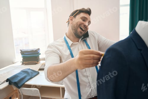 Preview: Happy Tailor Talks on Phone While Working