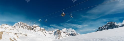 Preview: Ski Lift Over Snowy Mountains Wide Banner