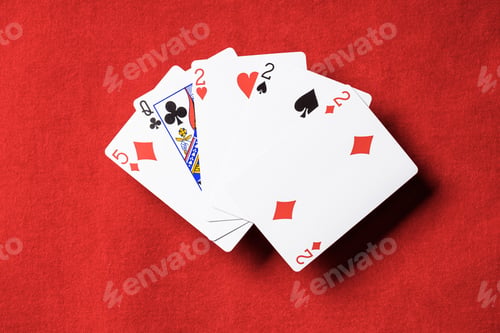 Preview: top view of red poker table and playing cards combination with different suits