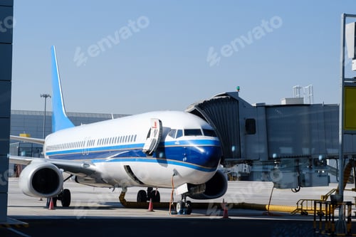Preview: Airplane parked at terminal gate ready for boarding with bright blue accents during