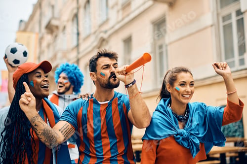 Preview: Happy soccer fans having fun while celebrating on the street during the world cup.
