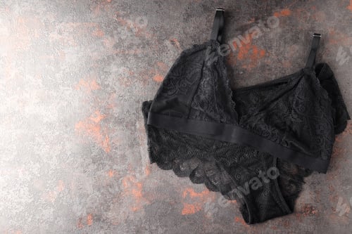 Preview: Black set of women's underwear on textured background