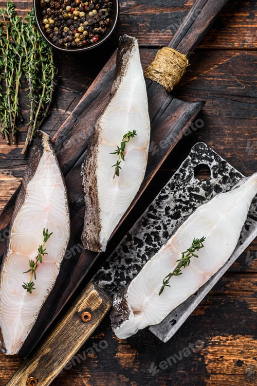 Preview: Raw halibut fish steak. Dark wooden background. Top view
